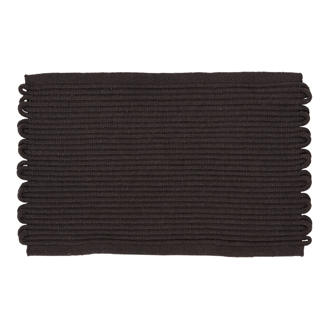 Black rectangular mat with textured ridges and decorative scalloped edges. Perfect for modern decor.