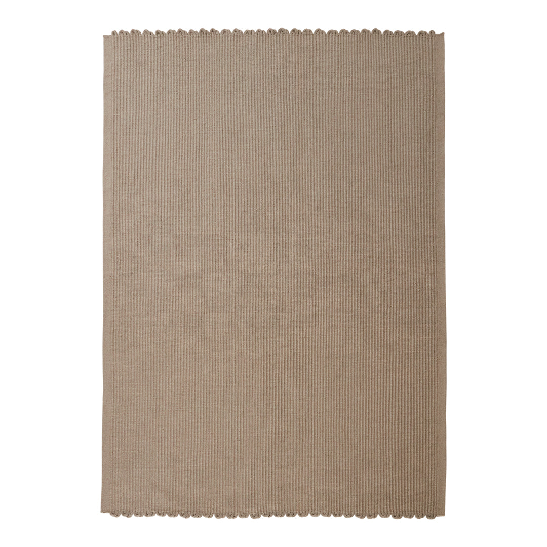 Beige linen placemat with a textured surface and scalloped edges. Perfect for elegant dining decor.