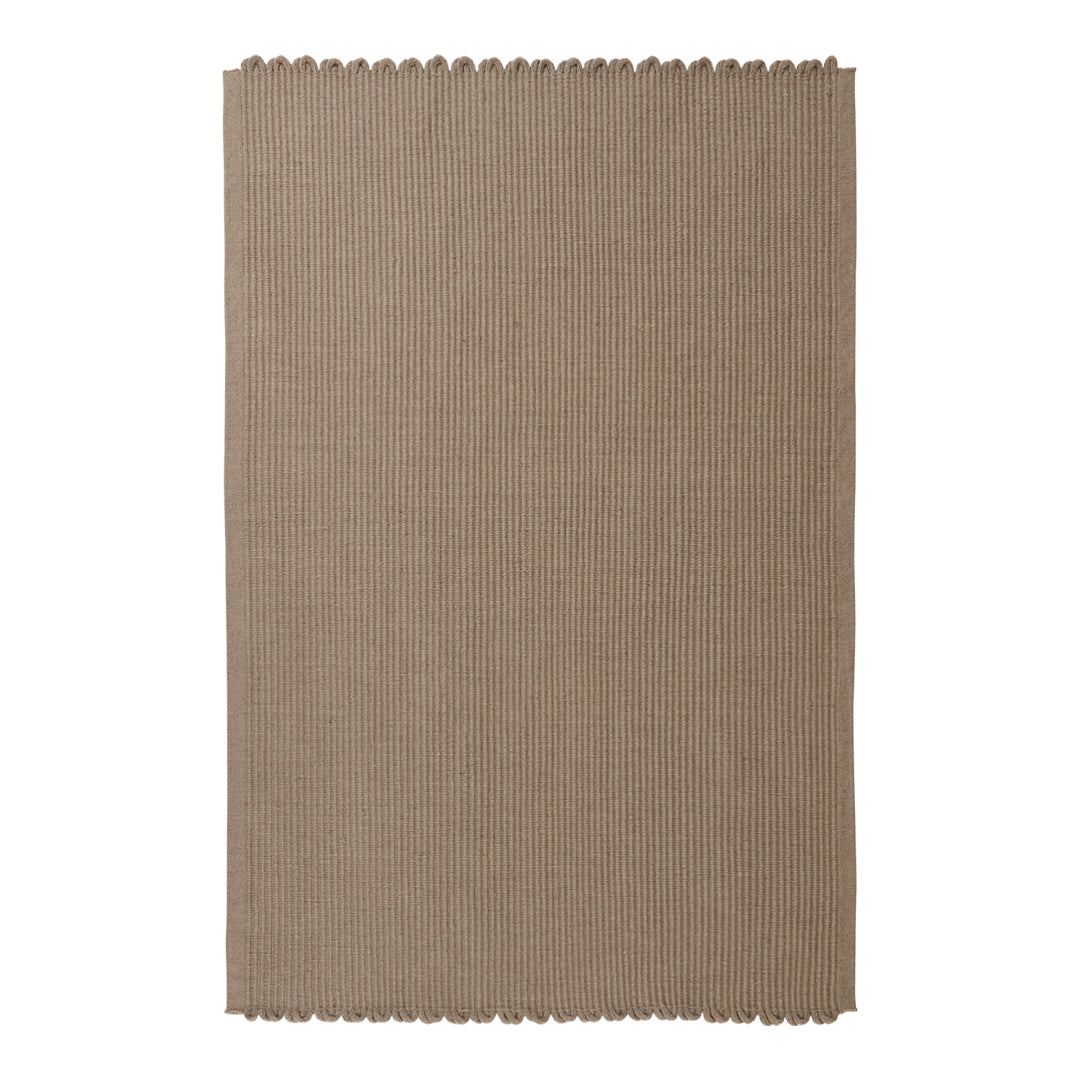 Taupe woven rug with a subtle texture and scalloped edges, ideal for adding warmth to any space.