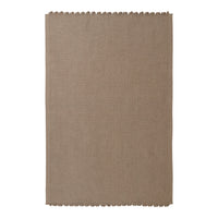 Taupe woven rug with a subtle texture and scalloped edges, ideal for adding warmth to any space.