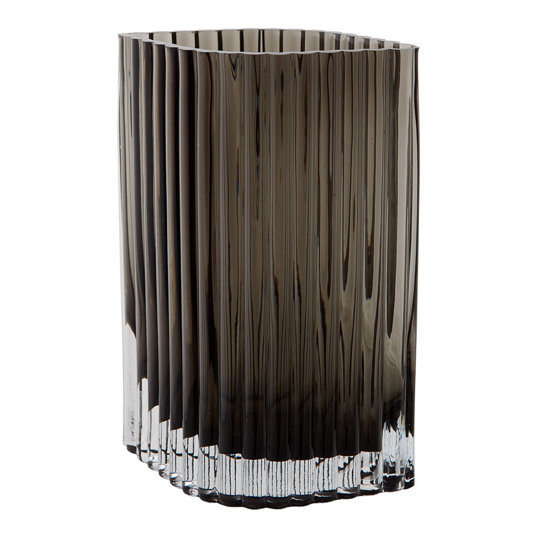 Smoky gray glass vase with vertical ribbed pattern and crystal clear base. Elegant home decor piece.