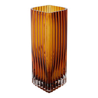 Amber glass vase with vertical ribbed pattern, showcasing warm hues and modern design.