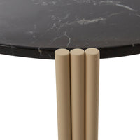 Black marble top with subtle white veining, supported by three beige cylindrical legs.
