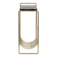 Gold metal magazine holder with sleek design and black marble accents, featuring a modern, minimalistic pattern.