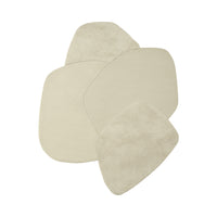 Neutral beige area rug set in organic shape, featuring soft textures and subtle variations, perfect for modern decor.