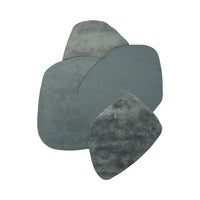 Soft teal-colored mats with varied textures and organic shapes, perfect for adding elegance to any space.