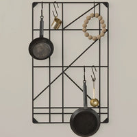 Black geometric wall rack with metal and wooden accents, featuring circular and linear patterns.