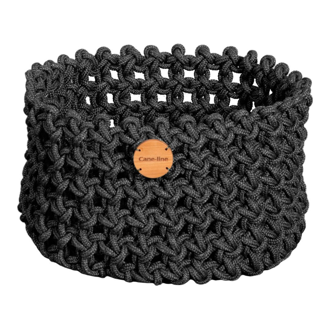 Textured dark gray woven basket with a rustic wooden tag, featuring a unique knotted pattern for stylish storage.