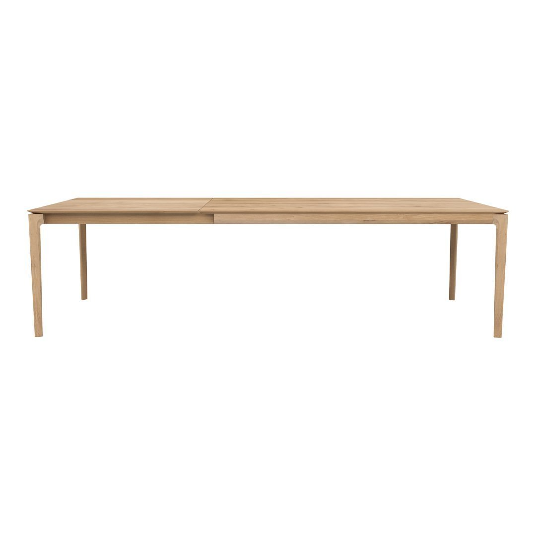 Light wood dining table with a minimalist design, featuring a smooth, natural finish and clean lines.
