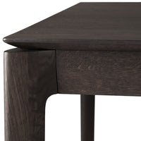 Dark oak table featuring smooth, sleek edges and a rich, textured grain pattern. Perfect for modern decor.
