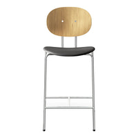 Stylish bar stool with a natural wood backrest, sleek black seat, and shiny chrome legs for a modern look.