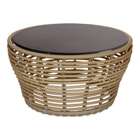 Round wicker coffee table with a natural tan base and sleek dark brown top. Perfect blend of textures and colors.