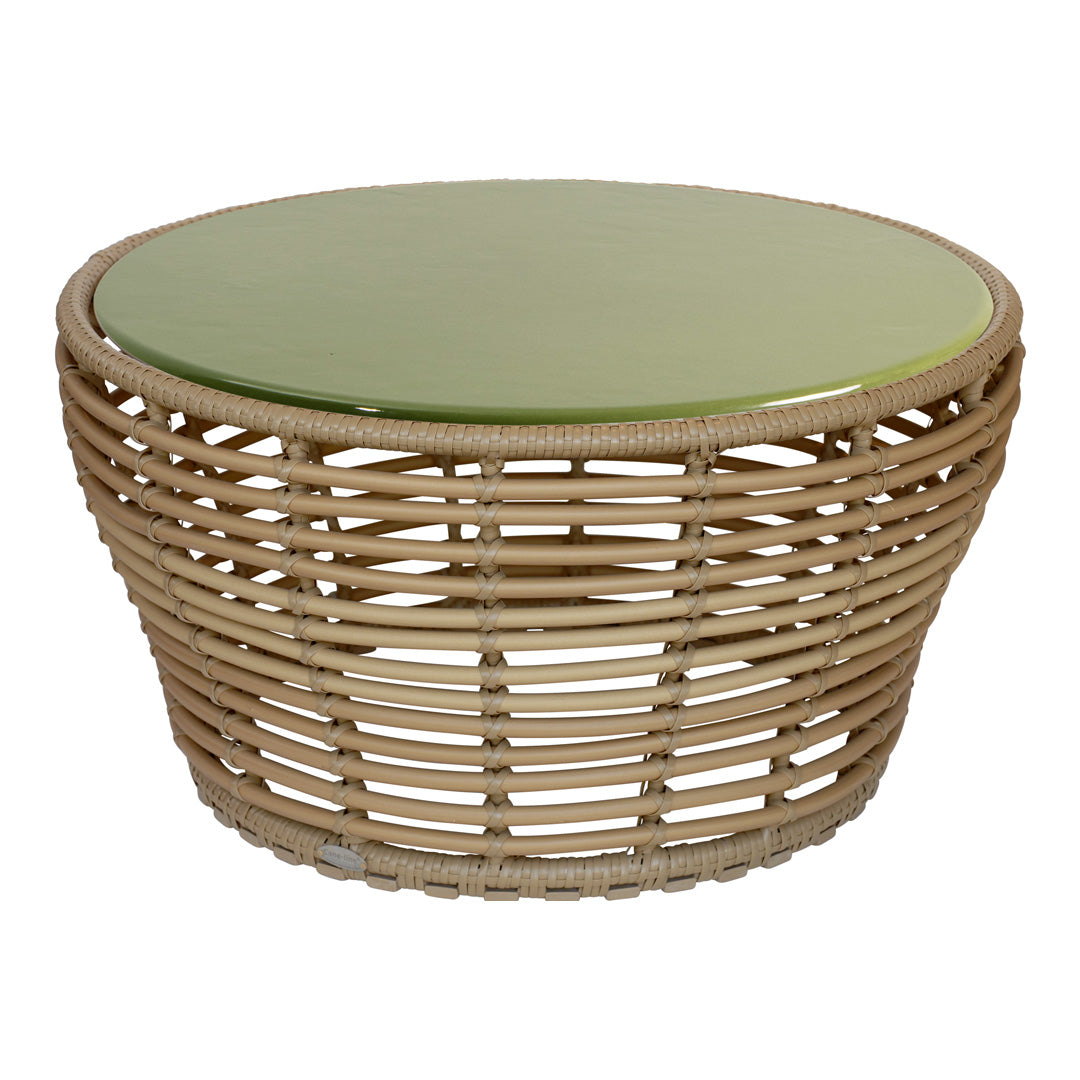 Round wicker coffee table with a natural beige base and a smooth, glossy green top.