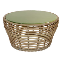 Round wicker coffee table with a natural beige base and a smooth, glossy green top.