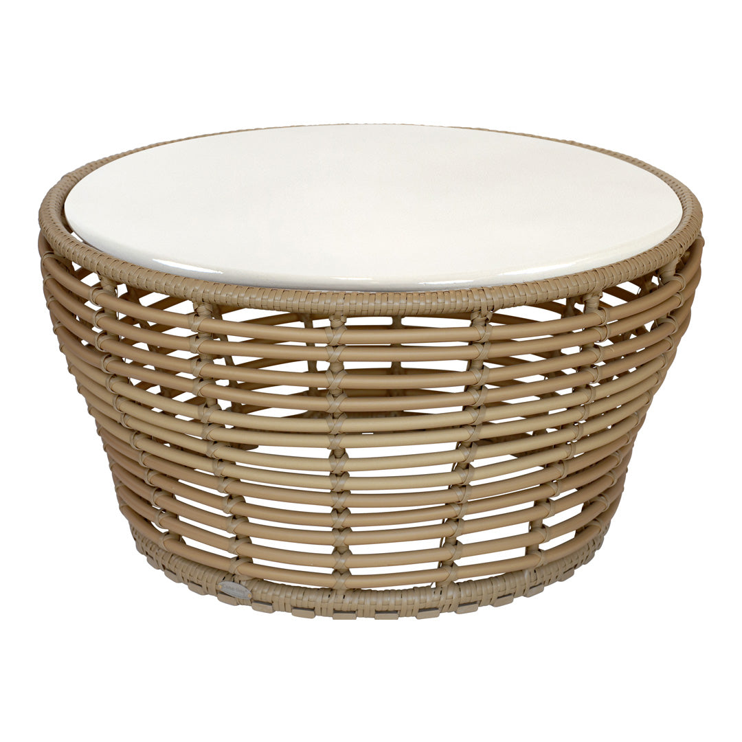 Round woven coffee table in natural rattan with a smooth white top, showcasing a minimalist design. Perfect for chic decor.