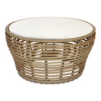 Round woven coffee table in natural rattan with a smooth white top, showcasing a minimalist design. Perfect for chic decor.