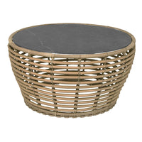 Round woven coffee table with a natural tan base and a sleek black stone top, featuring a unique basketweave pattern.