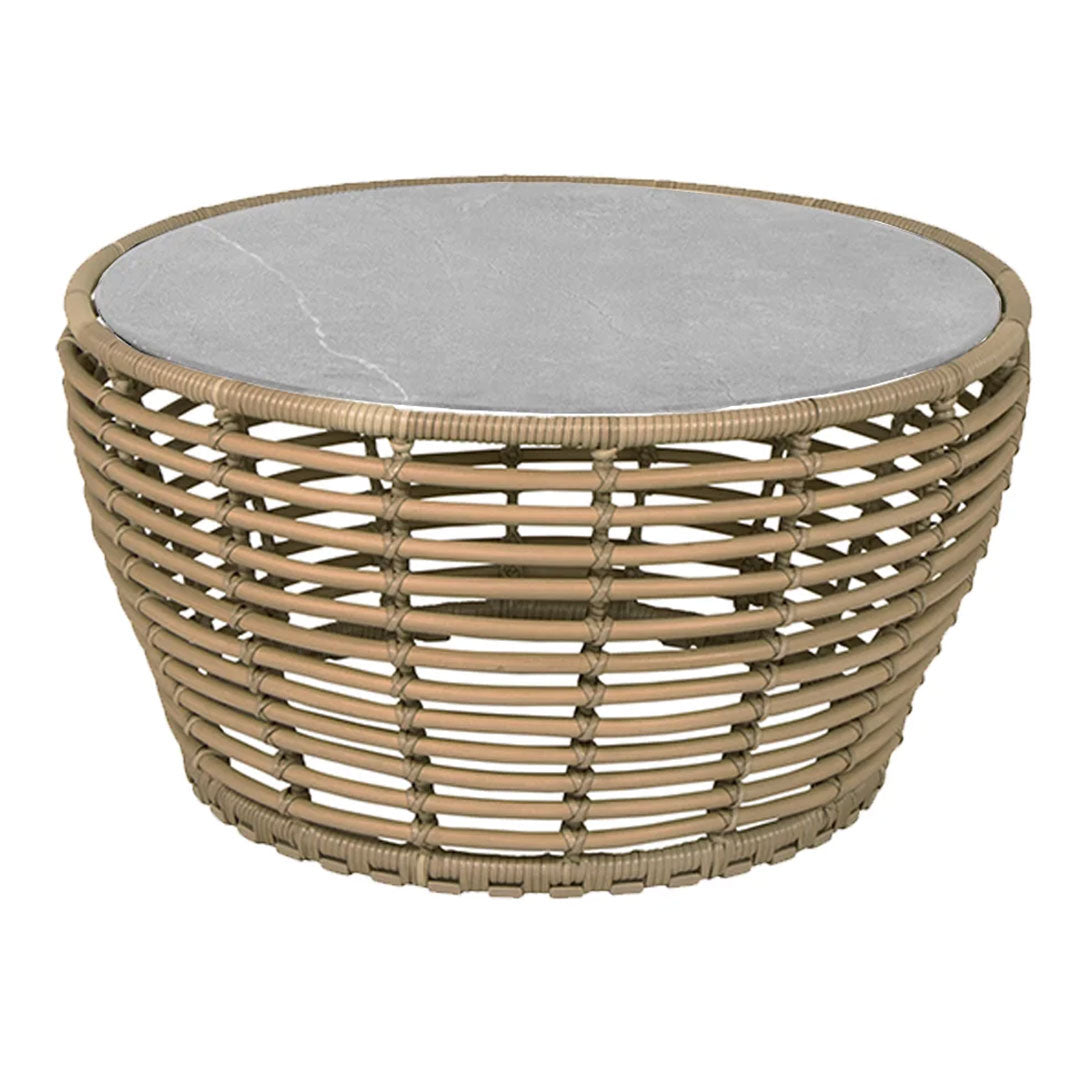 Round coffee table featuring a natural rattan base and a sleek gray marble top. Elegant and contemporary design.
