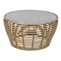 Round coffee table featuring a natural rattan base and a sleek gray marble top. Elegant and contemporary design.