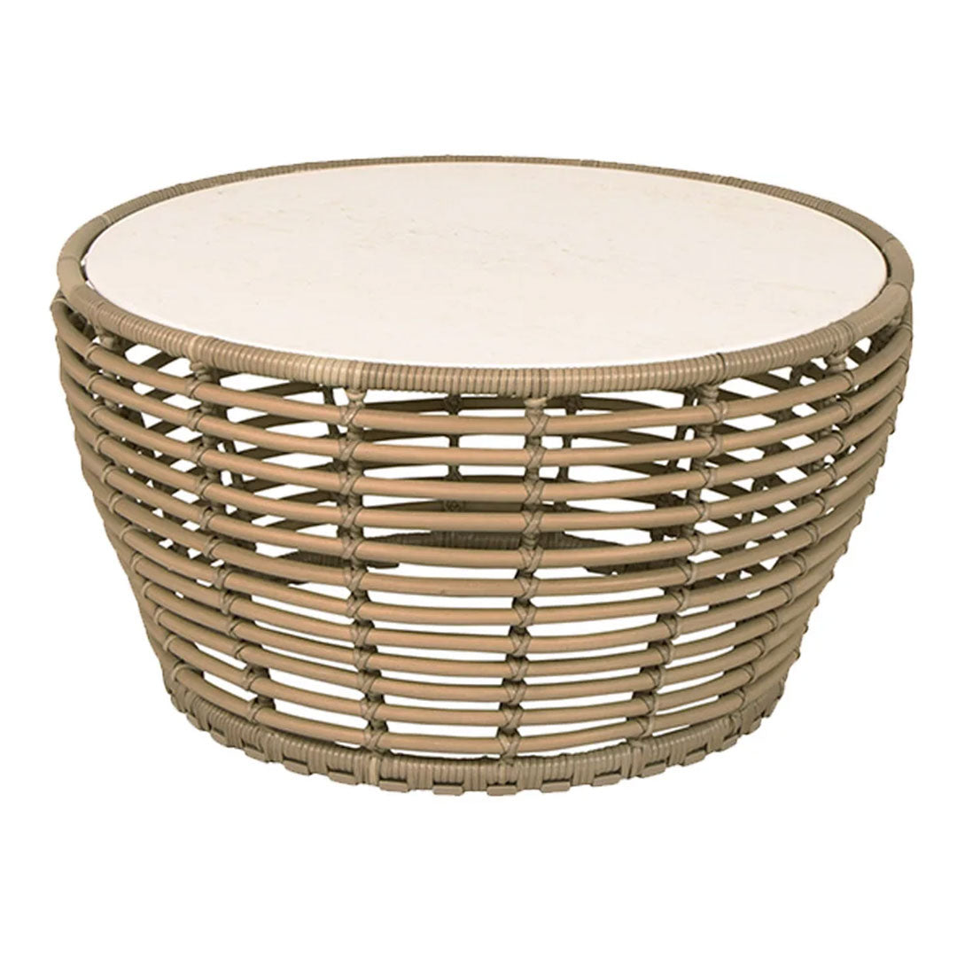 Round woven coffee table with natural tan hues and a smooth white top. Stylish and modern design for any space.