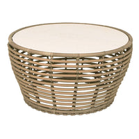 Round woven coffee table with natural tan hues and a smooth white top. Stylish and modern design for any space.