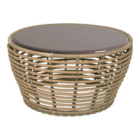 Round wicker coffee table in natural tones with a smooth, dark brown glass top. Stylish lattice pattern design.