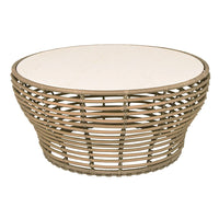 Round woven rattan coffee table with a natural beige finish and smooth white tabletop. Ideal for modern decor.