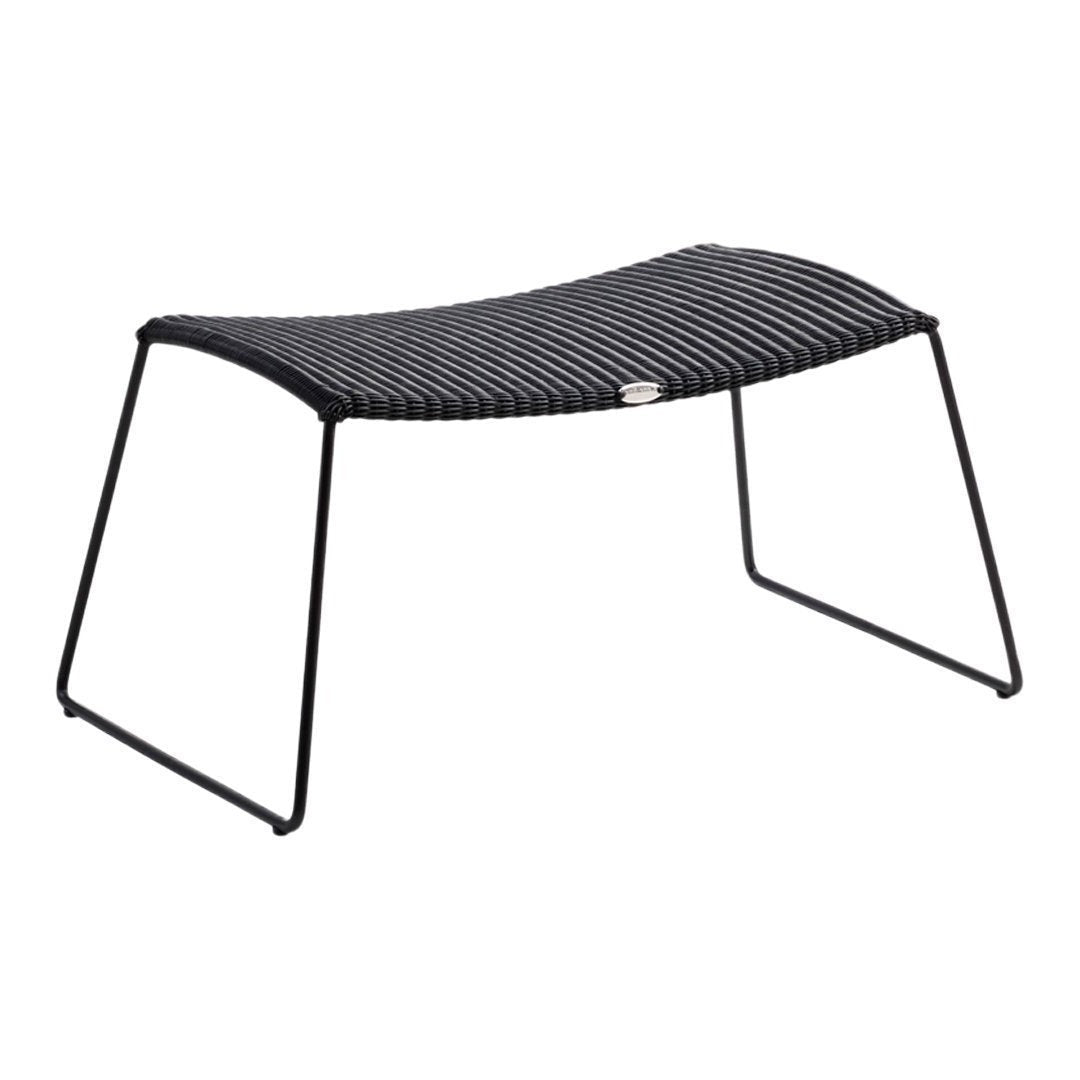 Black striped ottoman with a sleek design and sturdy black metal frame, perfect for modern decor.