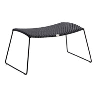 Black striped ottoman with a sleek design and sturdy black metal frame, perfect for modern decor.