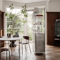 "Modern interior with a neutral color palette, wooden textures, sleek metallic accents, and greenery enhancing the space."