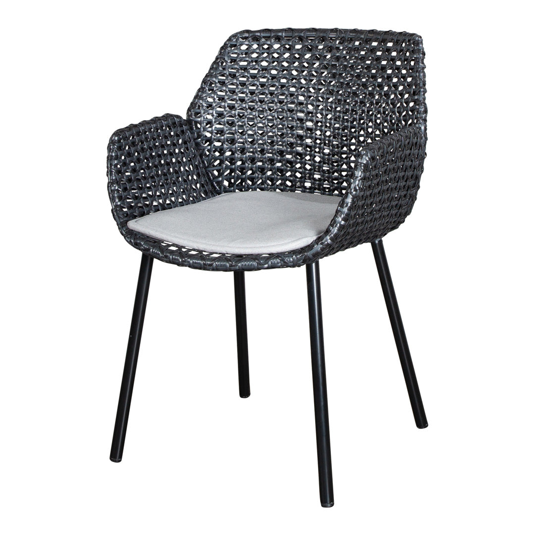 Black woven chair with contrasting white cushion, featuring a modern, stylish pattern. Ideal for outdoor or indoor use.