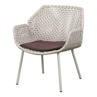 Light cream woven chair with a dark brown cushion and minimalist steel legs, showcasing a modern, stylish design.