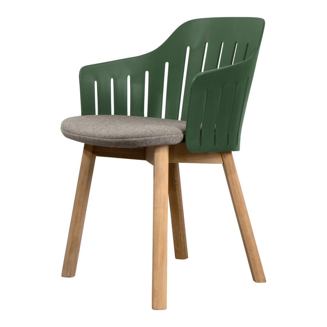 Green slatted chair with a gray cushion and natural wooden legs, blending modern design with earthy tones.