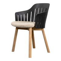 Black slatted armchair with a cozy beige upholstered seat and natural wood legs, blending modern and rustic styles.
