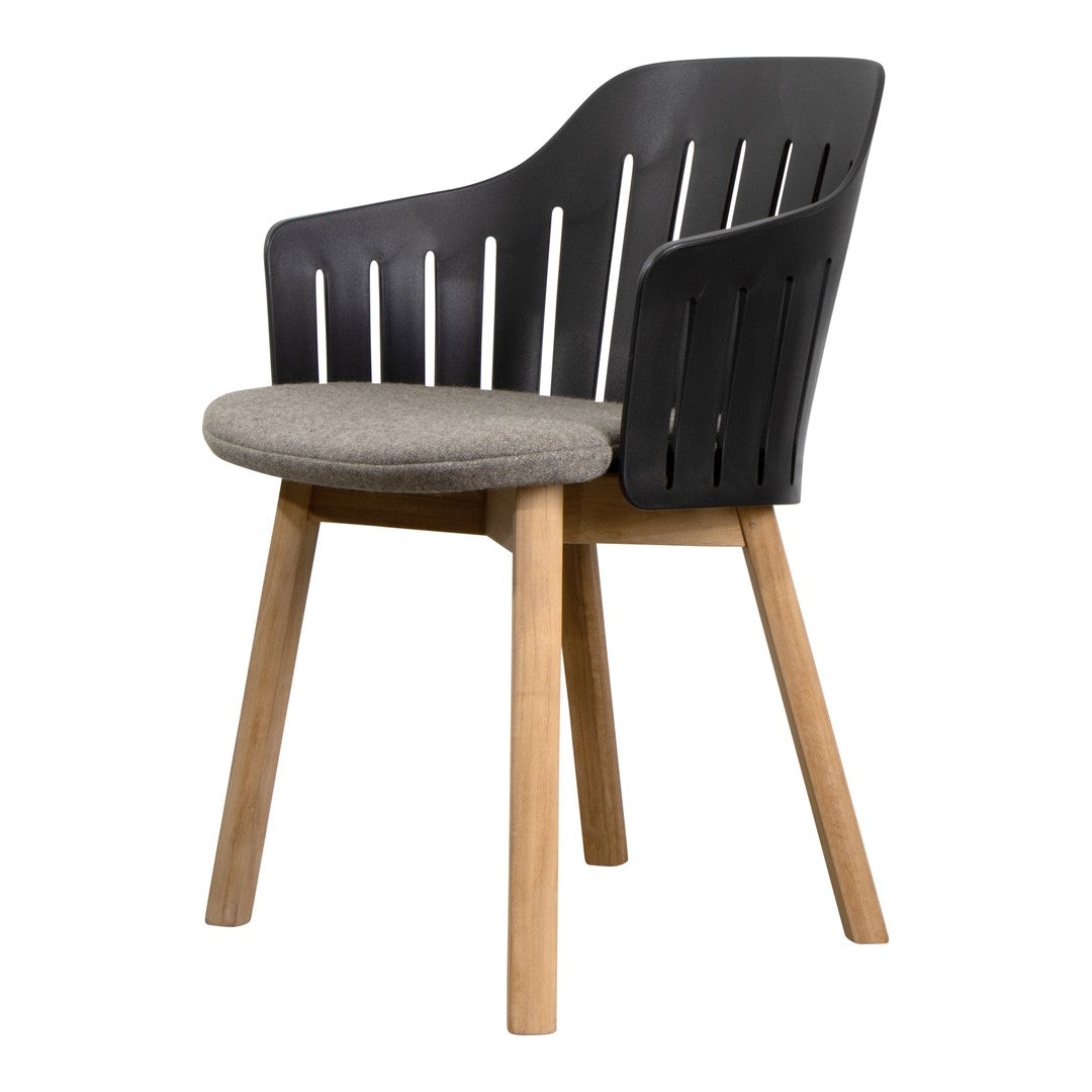 Black slatted chair with gray cushion and natural wood legs, featuring a modern, minimalist design.