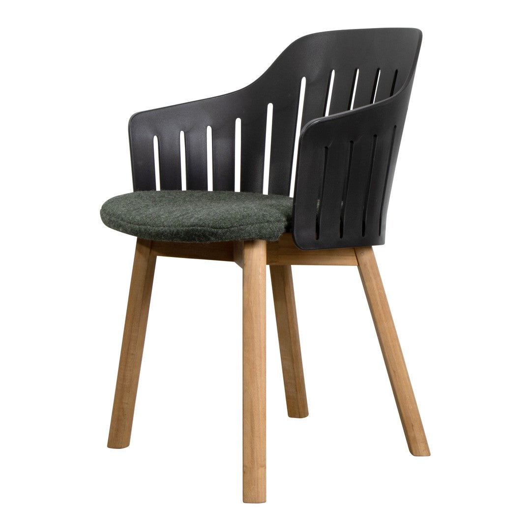 Stylish black armchair with slatted back and green upholstered seat, featuring natural wooden legs.