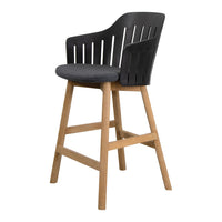 Black slatted back bar stool with a gray cushion and natural wood legs, blending modern and classic design elements.