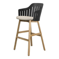 Stylish black and beige high chair with wooden legs, featuring a sleek, slatted back design. Modern and minimalistic.