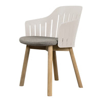 Modern white chair with slatted back, gray cushion, and natural wood legs for a contemporary look.