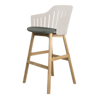 White slatted back high chair with a gray seat cushion and natural wood legs. Stylish and modern design.