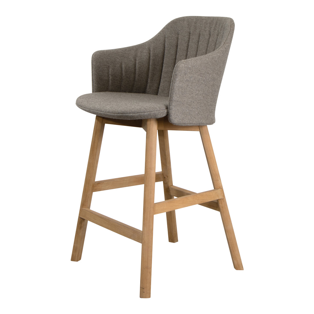 Gray upholstered bar stool with a ribbed pattern and natural wood legs, perfect for modern home decor.