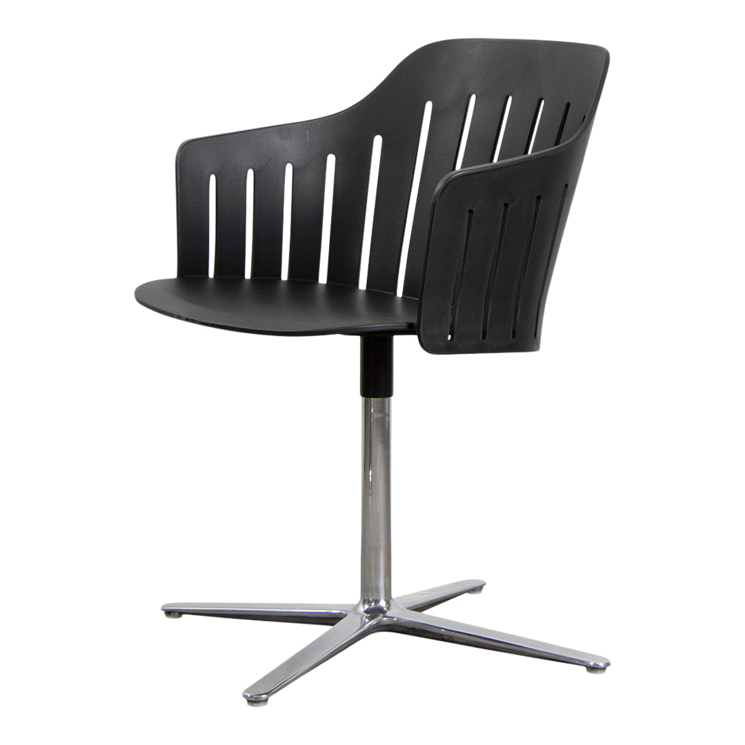 Black plastic chair with vertical slats and chrome metal base, featuring a sleek, modern design. Perfect for contemporary spaces.