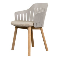 Textured cream upholstery and sleek light gray plastic with natural wood legs, ideal for contemporary decor.