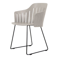 Light gray chair with slatted back, featuring a minimalist design and black metal legs for a modern aesthetic.