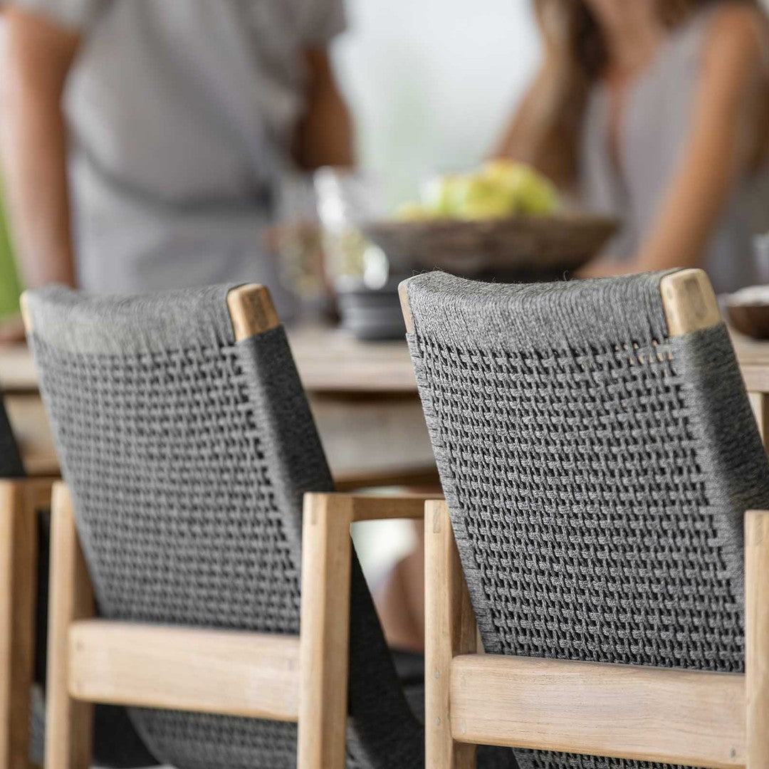 Gray woven chair backs with a light wood frame, showcasing modern patterns for a stylish dining area.