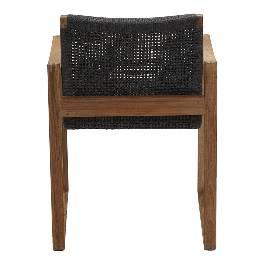 Black woven backrest on a wooden chair, showcasing a minimalist design with natural tones and textures.