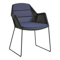 Black woven chair with textured navy blue fabric upholstery and sleek metal legs. Elegant and modern design.