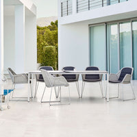 Modern outdoor dining set featuring grey and navy colors with clean lines and a sleek, minimalist design.