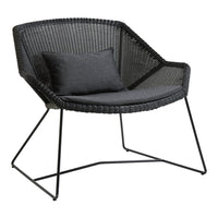 Black woven chair featuring a sleek design and dark gray cushion for a modern, stylish look.