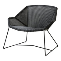 Black woven chair with a modern geometric pattern and sleek metal frame. Ideal for contemporary decor.